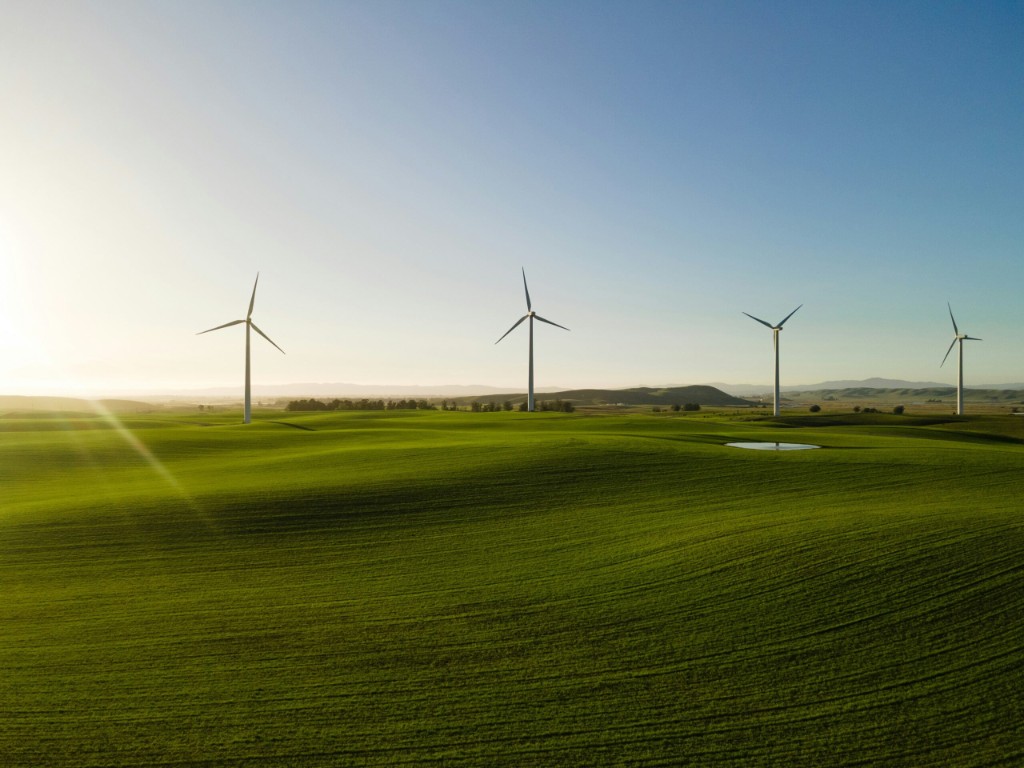 Wind turbines on green hills — clean energy and environmental care