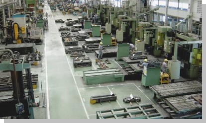 Injection molding production floor with rows of industrial machinery