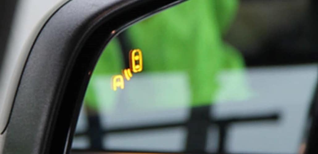 Side-view mirror with blind spot detection indicator illuminated