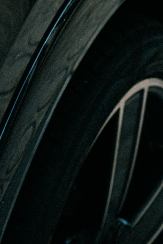 Flexible wheel-arch trim beside a tyre