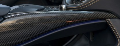 Real carbon-fiber interior trim on a door and console line